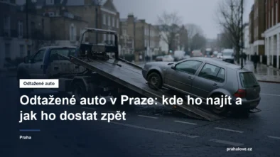 Odtahový vůz nakládá osobní auto v městské ulici