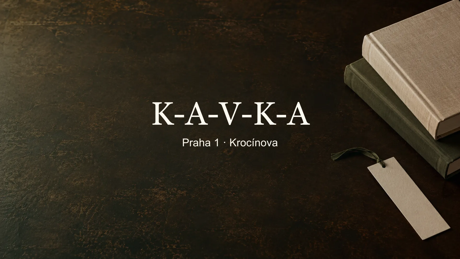 Tematické zátiší knih a papíru s titulkem K-A-V-K-A, Praha 1 · Krocínova