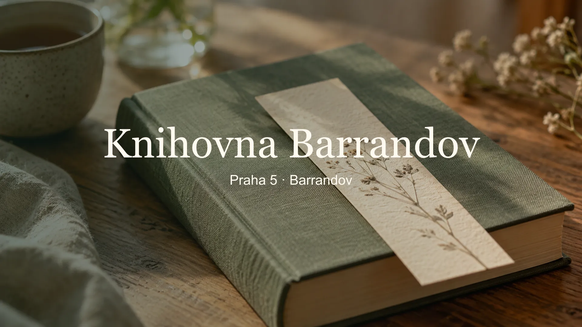 Zátiší s knihou a papírovou záložkou, titulek Knihovna Barrandov, Praha 5 · Barrandov