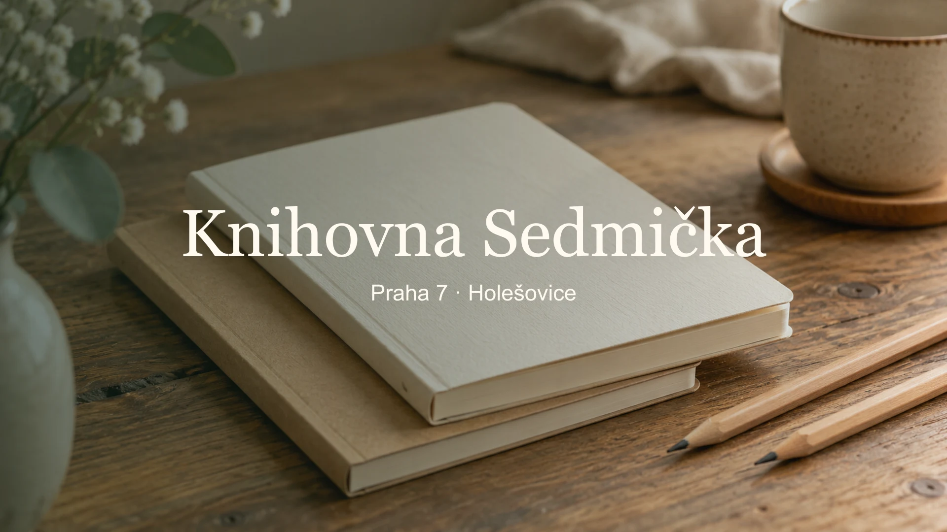 Zátiší s čistými zápisníky a tužkami, titulek Knihovna Sedmička v Holešovicích, Praha 7 · Holešovice